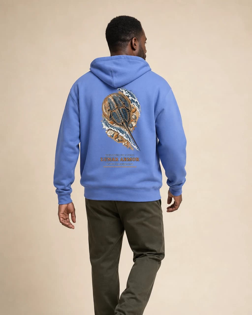 Adult wearing the Lunar Armor hoodie in Carolina Blue, back view