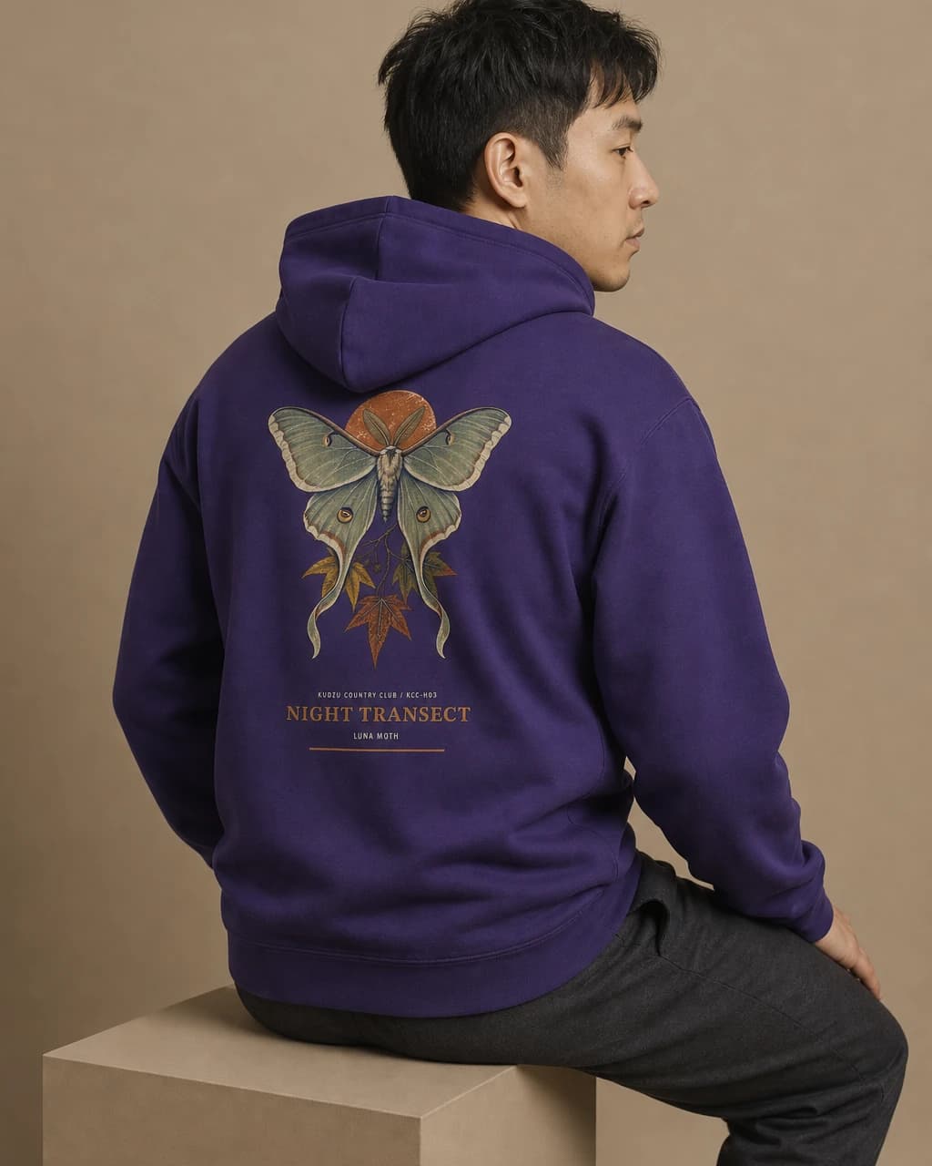 Adult wearing the Night Transect hoodie in Purple, back view