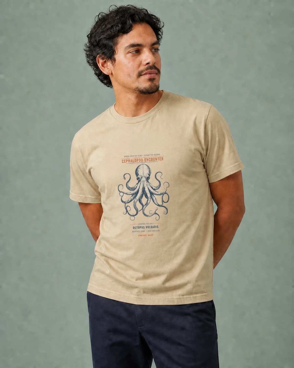 Adult wearing the Cephalopod Encounter tee in Soft Cream