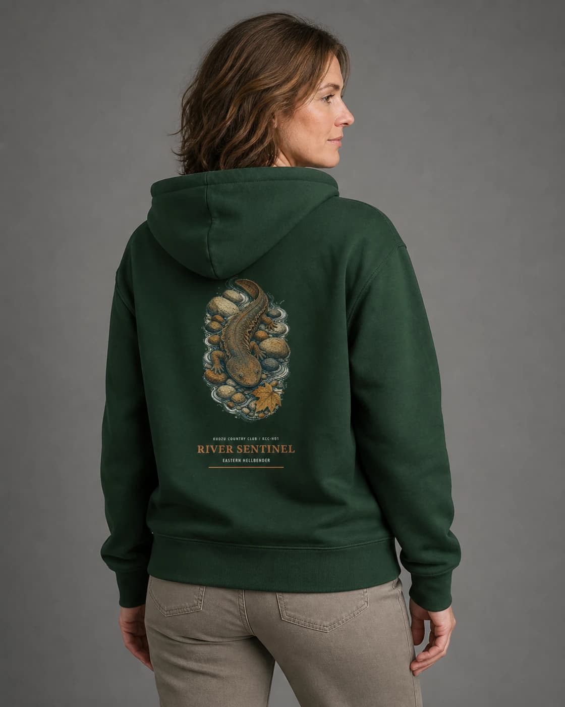 Adult wearing the River Sentinel hoodie in Dark Green, back view