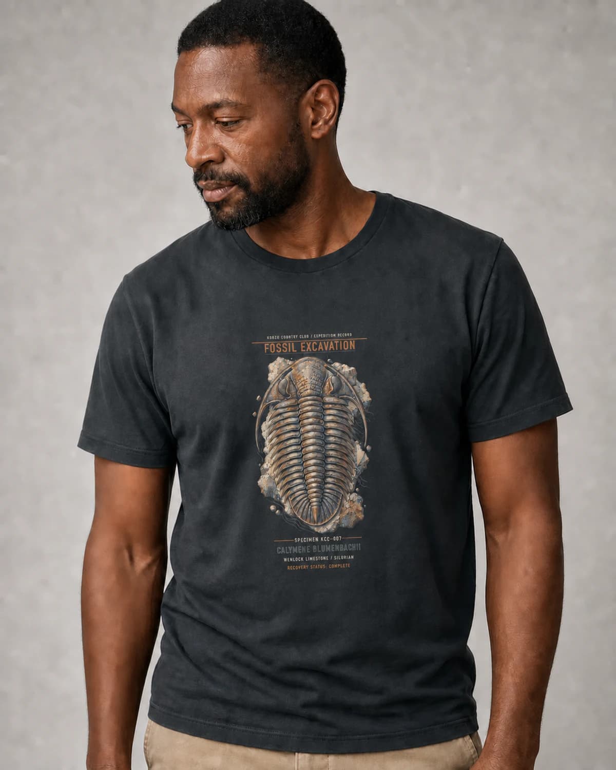 Adult wearing the Fossil Excavation tee in Dark Grey