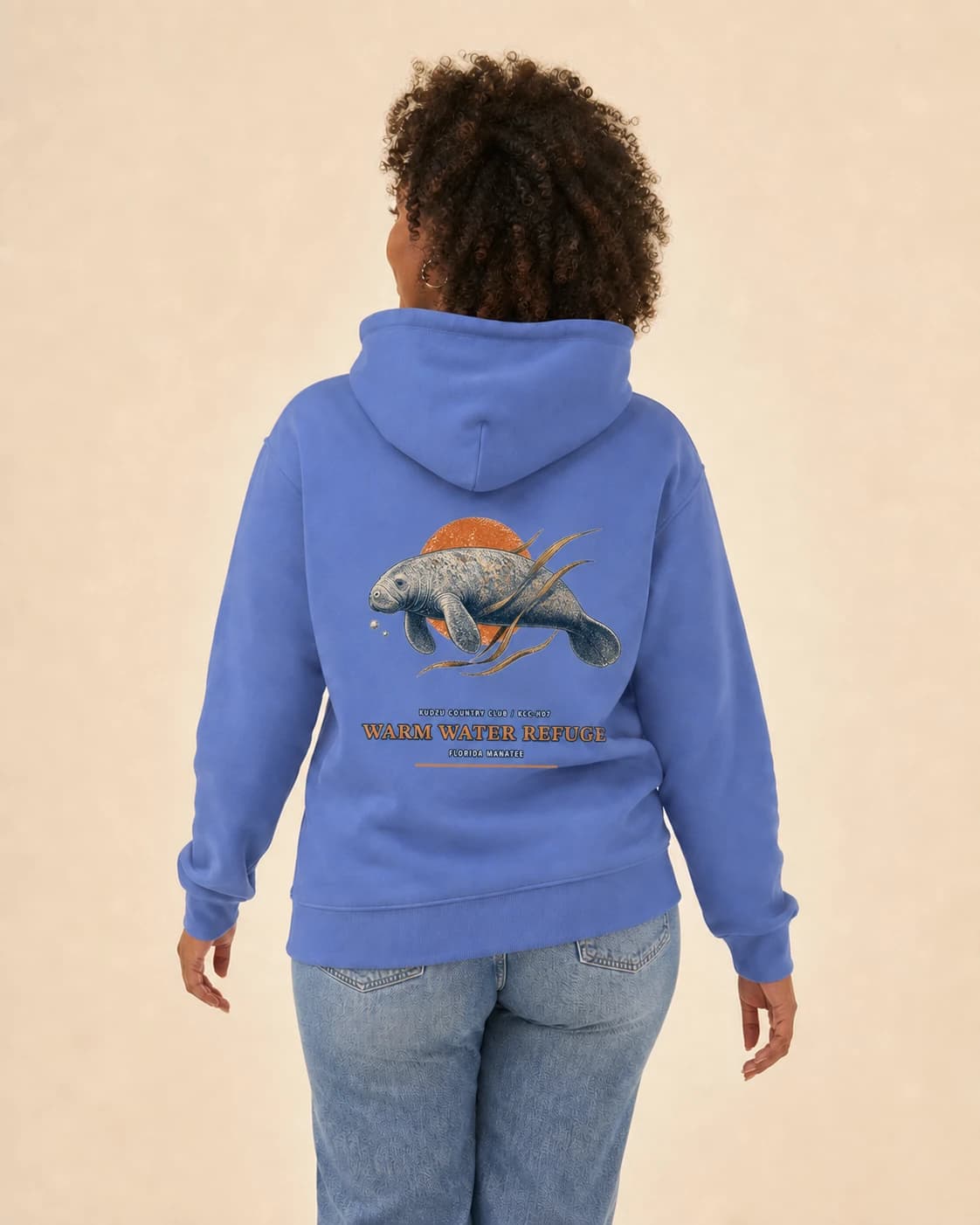 Adult wearing the Warm Water Refuge hoodie in Carolina Blue, back view